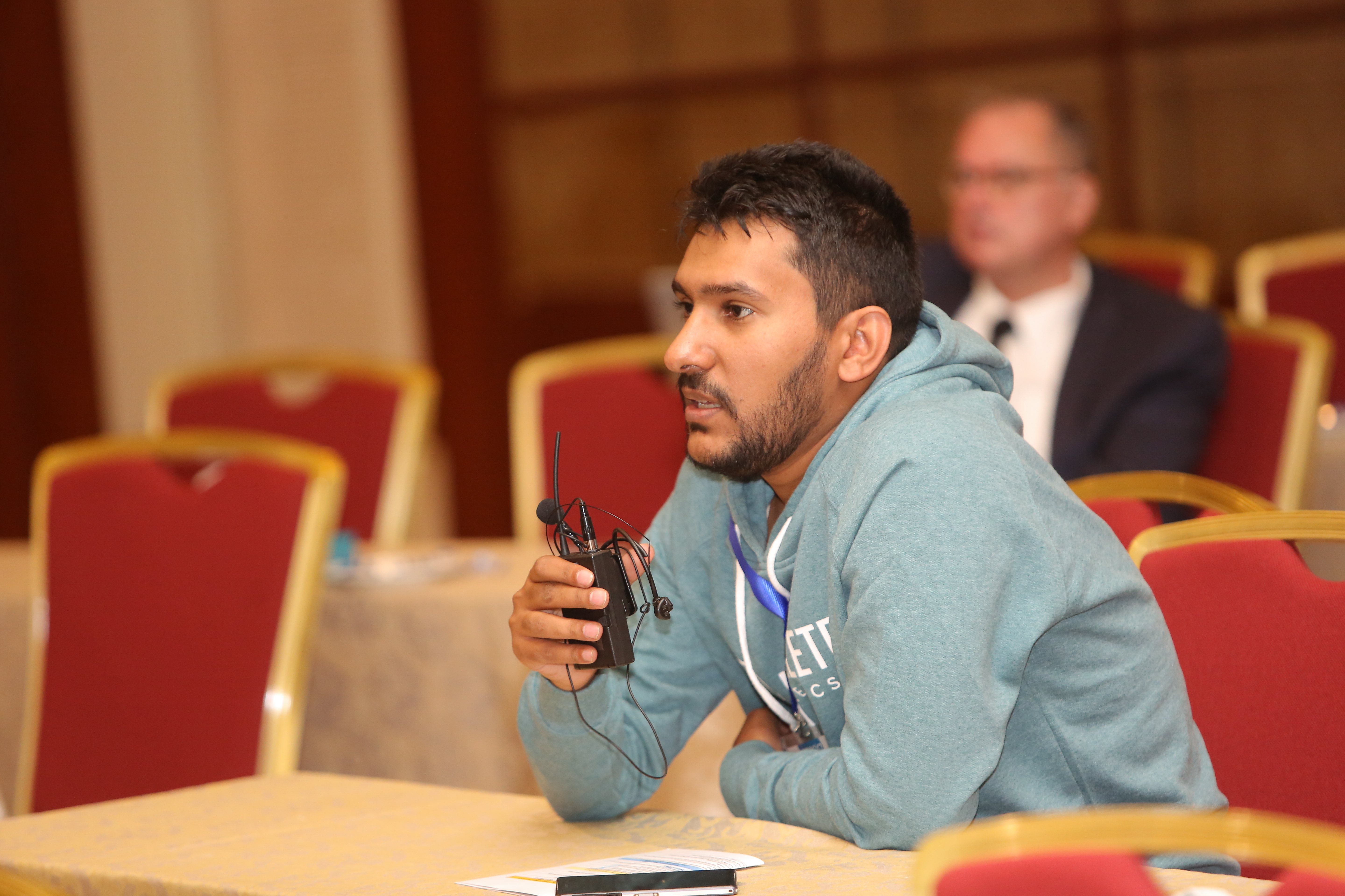 Muayyad Alsadi seated at a conference in Amman.